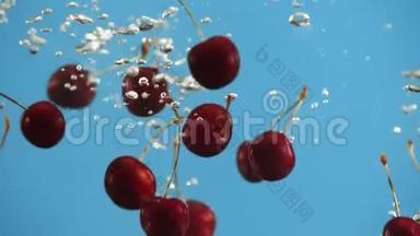 在蓝色背景下，成熟的樱桃会<strong>掉进水里</strong>。 液态红色浆果